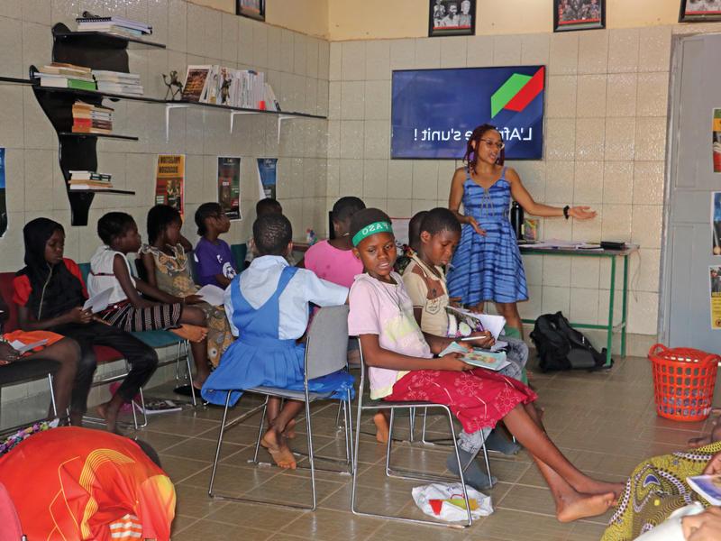 A classroom in West Africa with a teacher and a dozen children